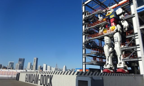 「ガンダムファクトリー横浜」ガンダムドック内の動くガンダムとみなとみらいの景色