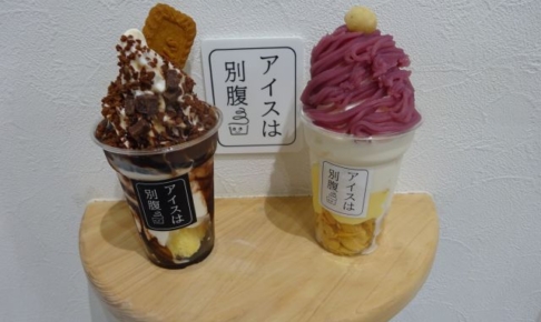 「アイスは別腹横浜関内店」で購入したモーツァルトと紅芋モンブランのパフェを店内撮影スポットの棚に置いたところ（アイスは別腹と書いてある）